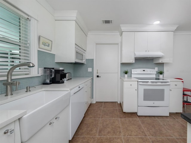 kitchen featuring decorative backsplash, white appliances, crown molding, sink, and white cabinetry