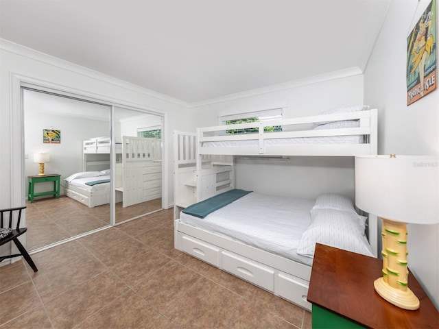 tiled bedroom featuring multiple windows, a closet, and crown molding