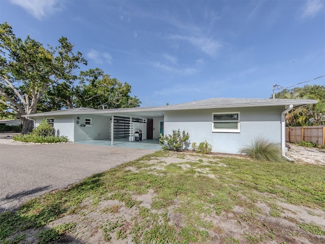 ranch-style home featuring a carport