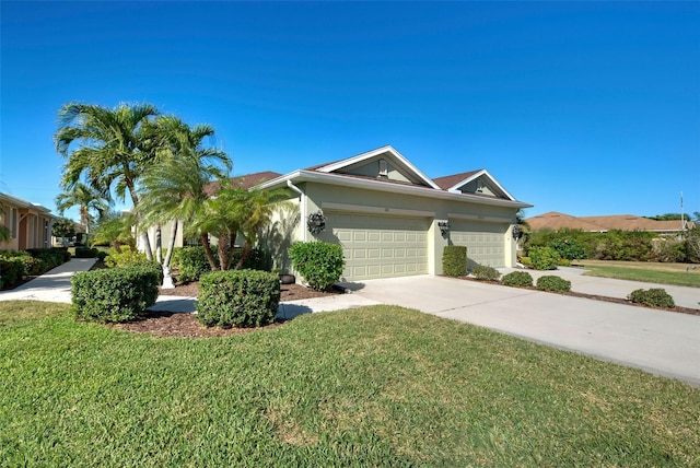 view of front facade with a front yard and a garage