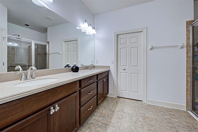 bathroom with tile patterned flooring, vanity, and an enclosed shower