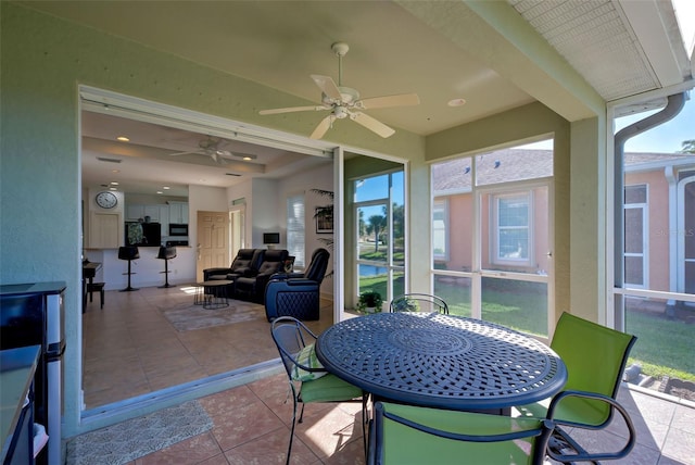 sunroom / solarium featuring ceiling fan