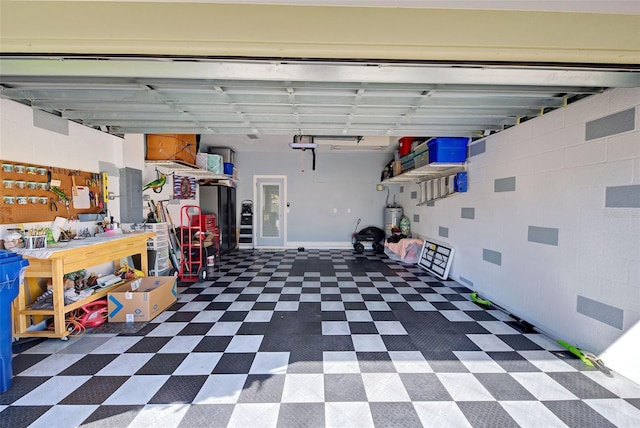 garage featuring a workshop area and water heater