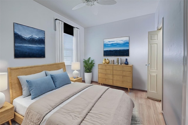 bedroom with light hardwood / wood-style floors and ceiling fan