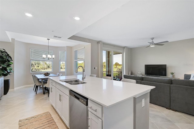 kitchen featuring white cabinetry, dishwasher, sink, hanging light fixtures, and a kitchen island with sink