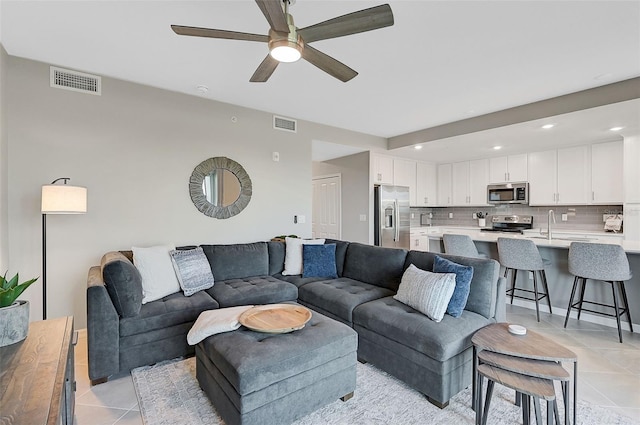 living room featuring a ceiling fan, recessed lighting, visible vents, and light tile patterned flooring