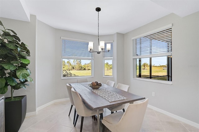 dining room featuring a chandelier, light tile patterned flooring, and baseboards