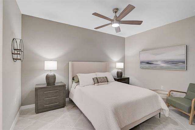 bedroom with ceiling fan, baseboards, and light tile patterned floors