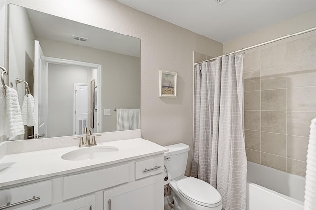 full bathroom with a textured wall, toilet, shower / tub combo, visible vents, and vanity