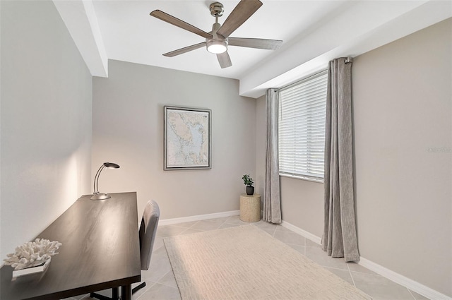 office with light tile patterned floors, ceiling fan, and baseboards