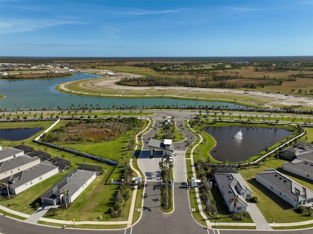 drone / aerial view with a water view and a residential view