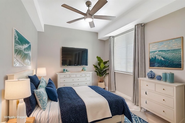 bedroom featuring baseboards, a ceiling fan, and light colored carpet