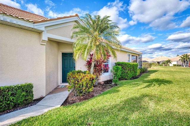 property entrance with a yard