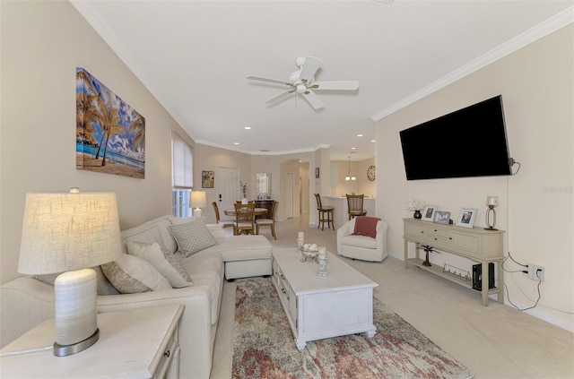 living room featuring light carpet, ceiling fan, and crown molding