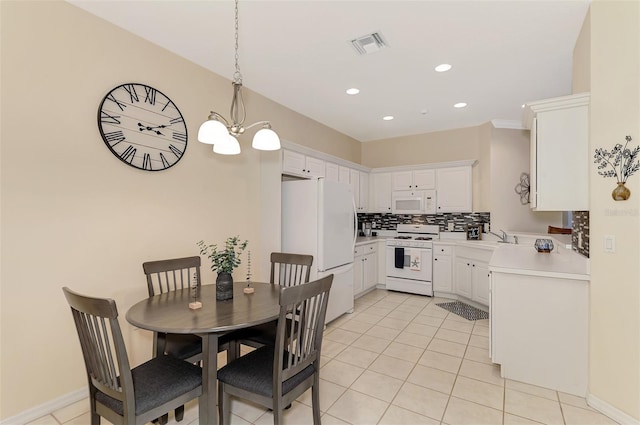 kitchen featuring white cabinets, white appliances, hanging light fixtures, and tasteful backsplash