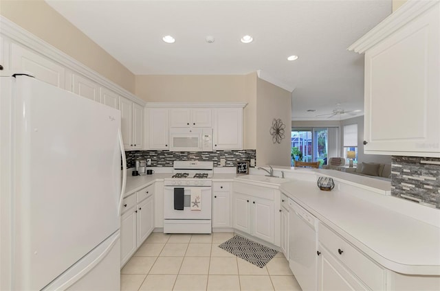 kitchen with kitchen peninsula, sink, white cabinets, and white appliances