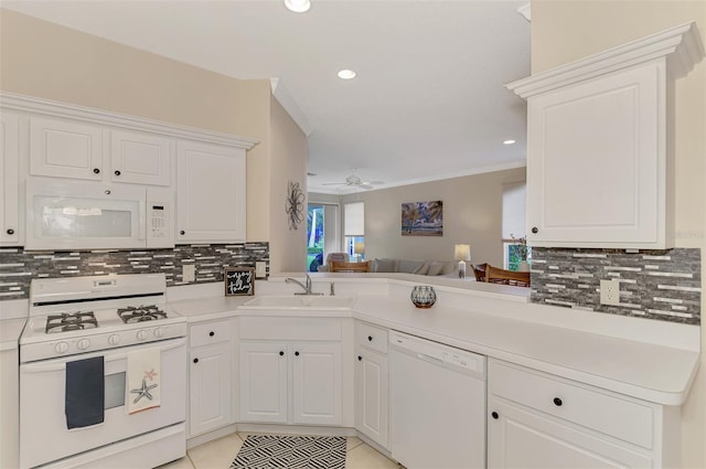 kitchen featuring sink, white cabinets, and white appliances