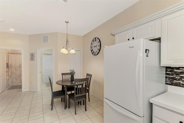 dining space with a notable chandelier and light tile patterned floors