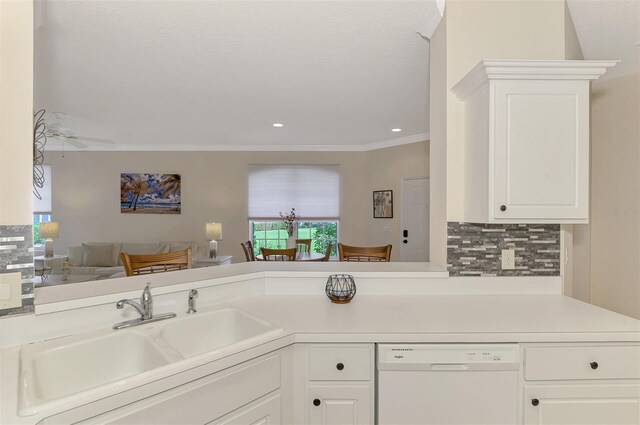 kitchen with white cabinetry, dishwasher, sink, kitchen peninsula, and decorative backsplash