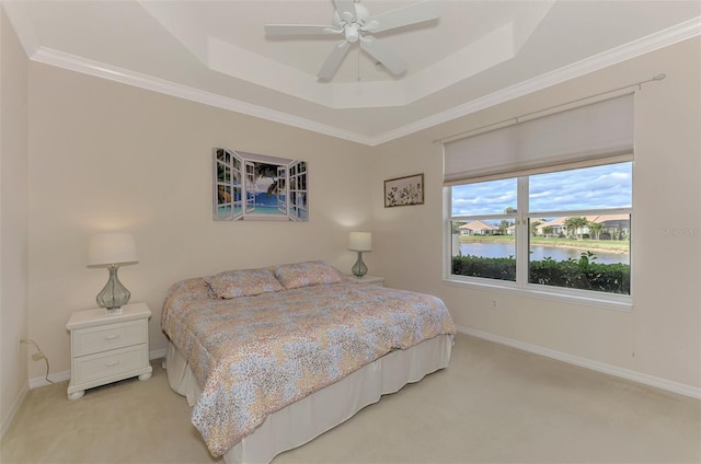 bedroom with ceiling fan, a water view, light carpet, and crown molding