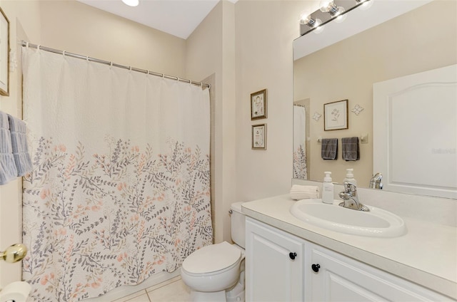 bathroom featuring tile patterned floors, vanity, and toilet