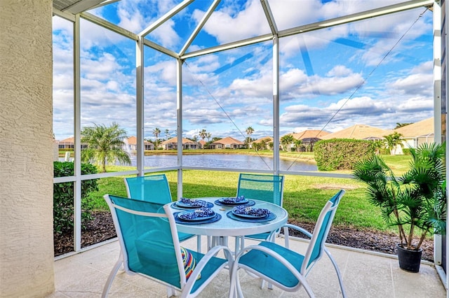 sunroom / solarium featuring a water view