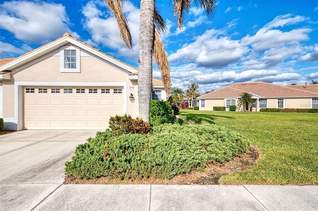 view of front of property featuring a front lawn and a garage