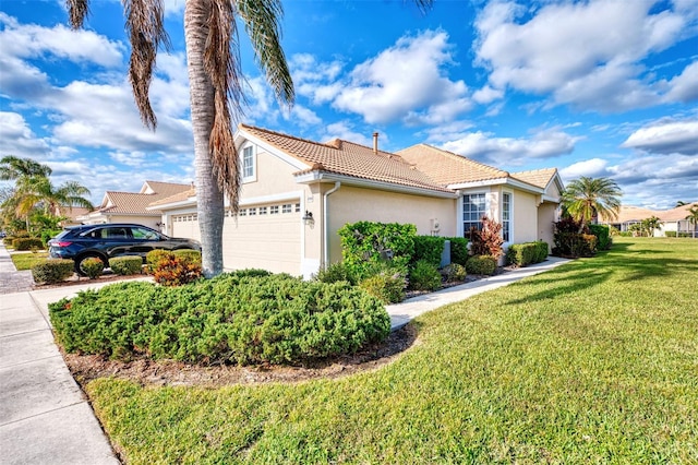 view of front of home with a front lawn and a garage