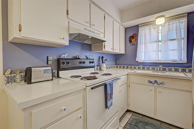 kitchen featuring white cabinets, light tile patterned floors, white range with electric stovetop, and sink