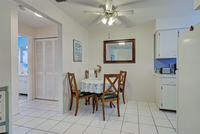 tiled dining area featuring ceiling fan