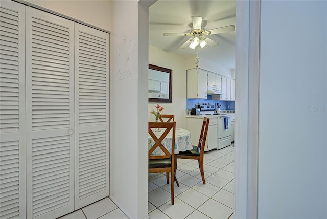 kitchen featuring ceiling fan, white cabinetry, white electric range, and light tile patterned floors