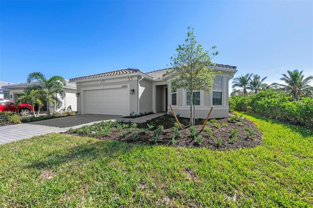 mediterranean / spanish-style home featuring a front lawn and a garage