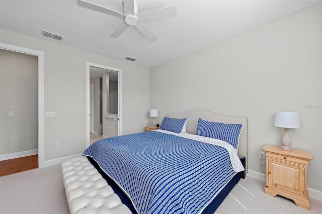 carpeted bedroom featuring ensuite bath and ceiling fan