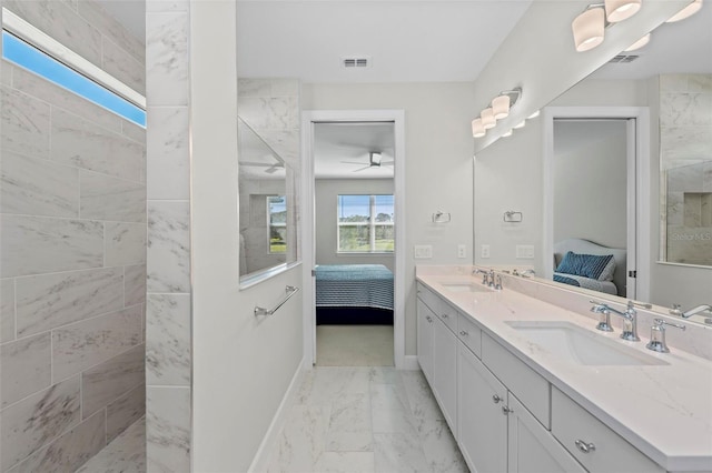 bathroom featuring a shower, ceiling fan, and vanity