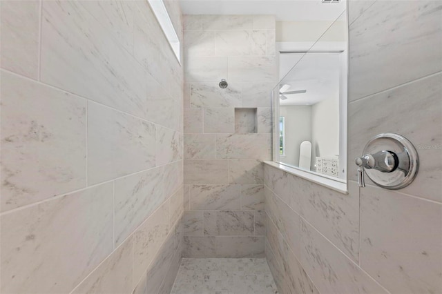 bathroom with tiled shower