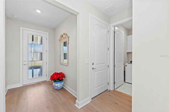 hall featuring washer / dryer and light wood-type flooring