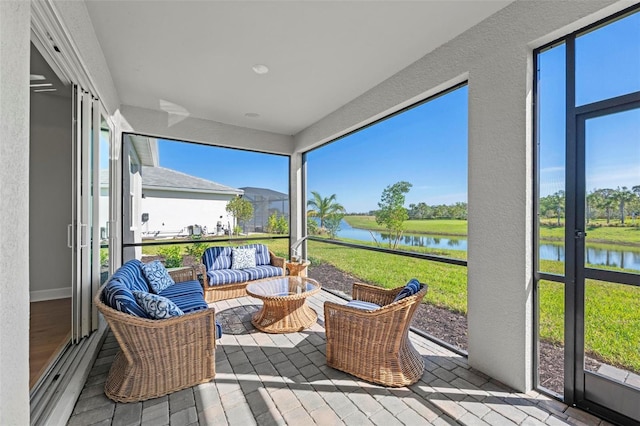 sunroom / solarium with a water view