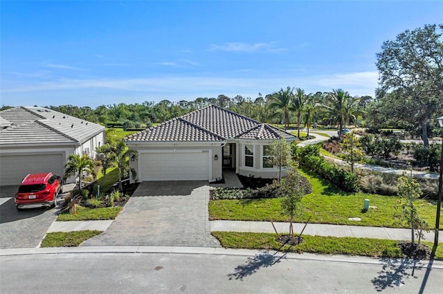 mediterranean / spanish-style house with a front yard and a garage