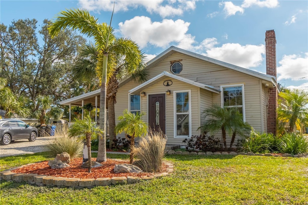 bungalow-style home with a front yard