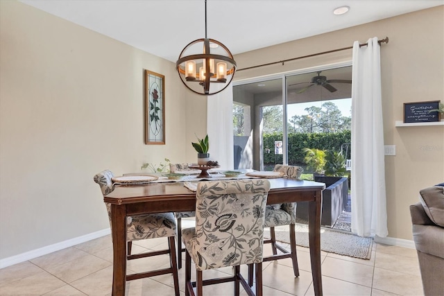 tiled dining room featuring ceiling fan with notable chandelier