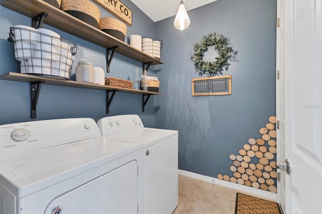 laundry area with light tile patterned floors and washer and clothes dryer