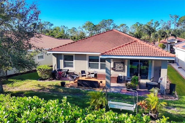 back of house with outdoor lounge area, a yard, and a patio