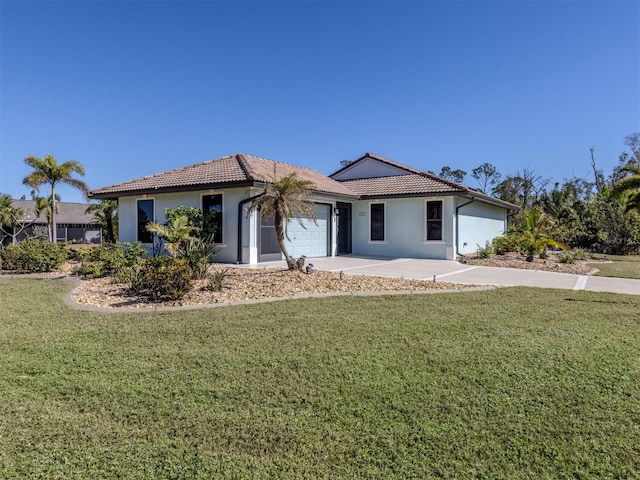 view of front of property with a front lawn and a garage