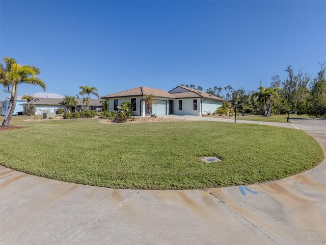 view of front of home featuring a garage and a front lawn