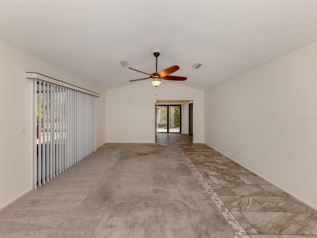 unfurnished room with a textured ceiling, light colored carpet, ceiling fan, and lofted ceiling