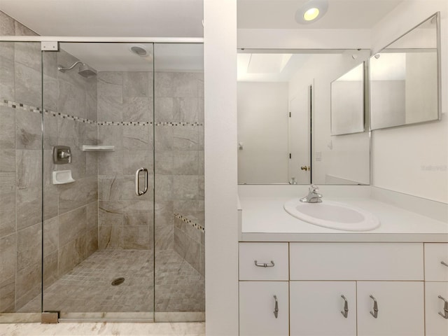 bathroom with vanity and a shower with shower door