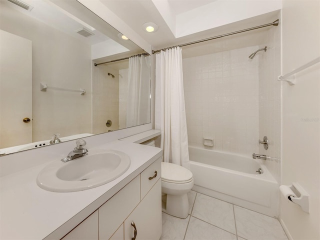 full bathroom featuring tile patterned floors, vanity, toilet, and shower / bath combo with shower curtain