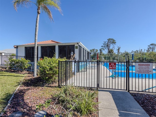 view of pool featuring a sunroom