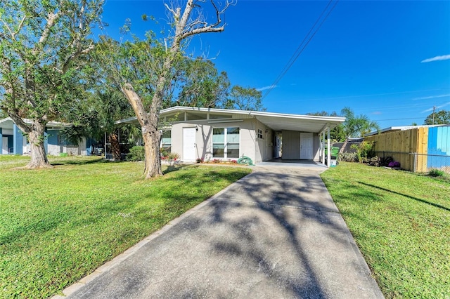 ranch-style house featuring a carport and a front lawn