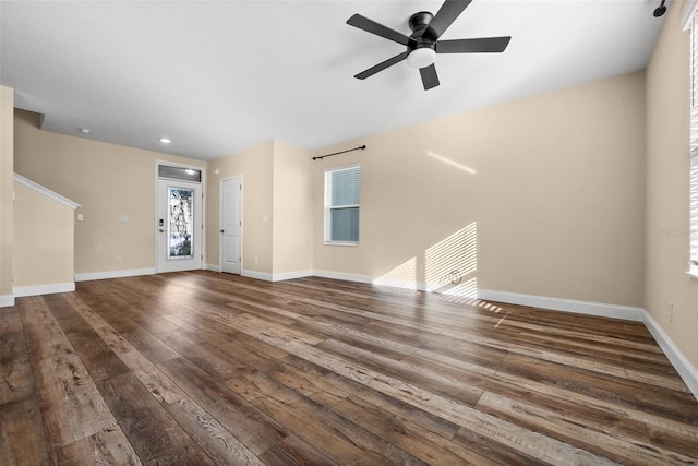 unfurnished living room with ceiling fan and dark hardwood / wood-style floors